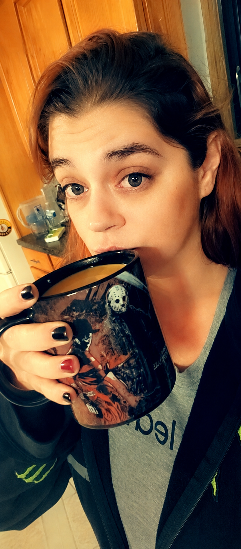 Savannah giving the camera a skeptical look over her horror-movie coffee mug